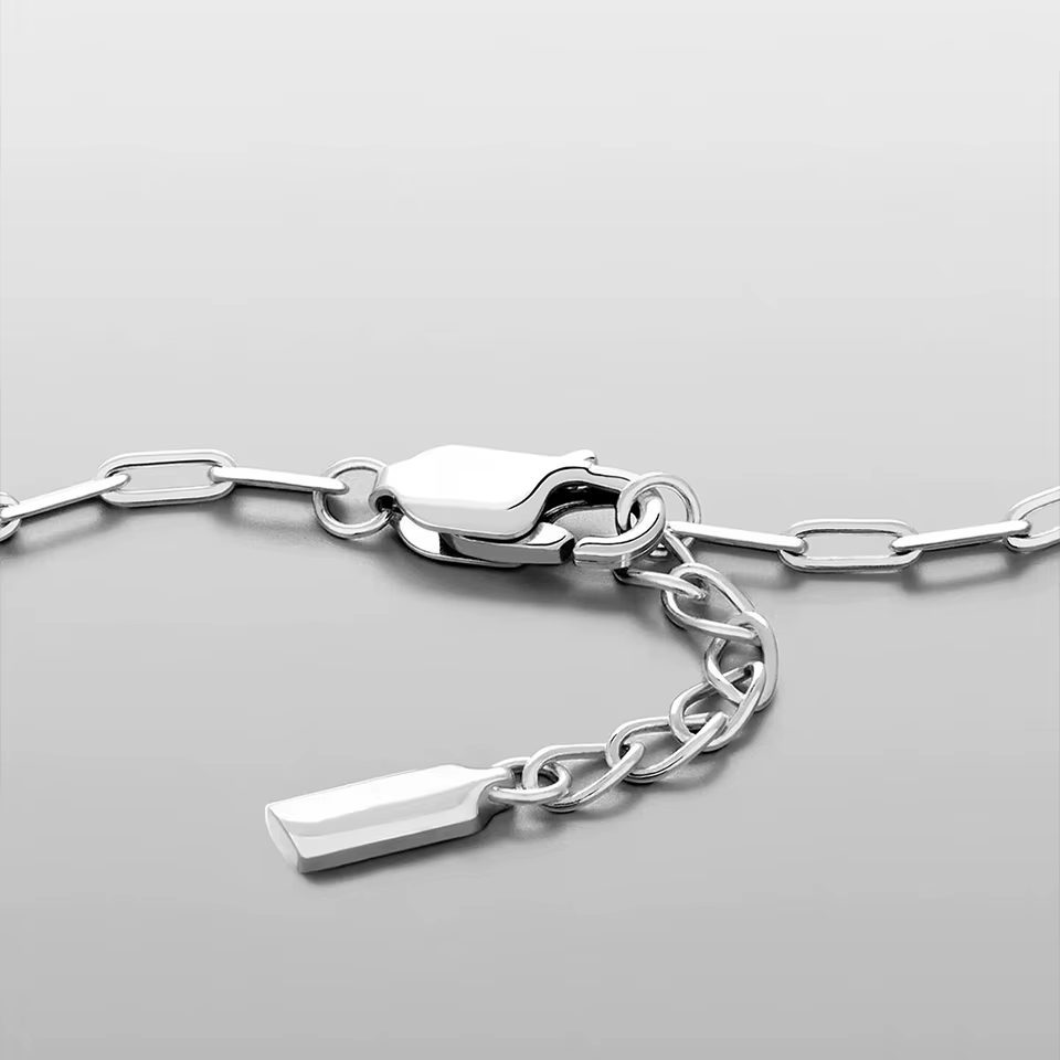 Silver chain bracelet with a clasp on a light gray background