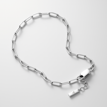 Silver chain bracelet with a tag on a light gray background